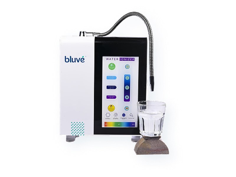 Bluvé alkaline water ionizer with a glass of water